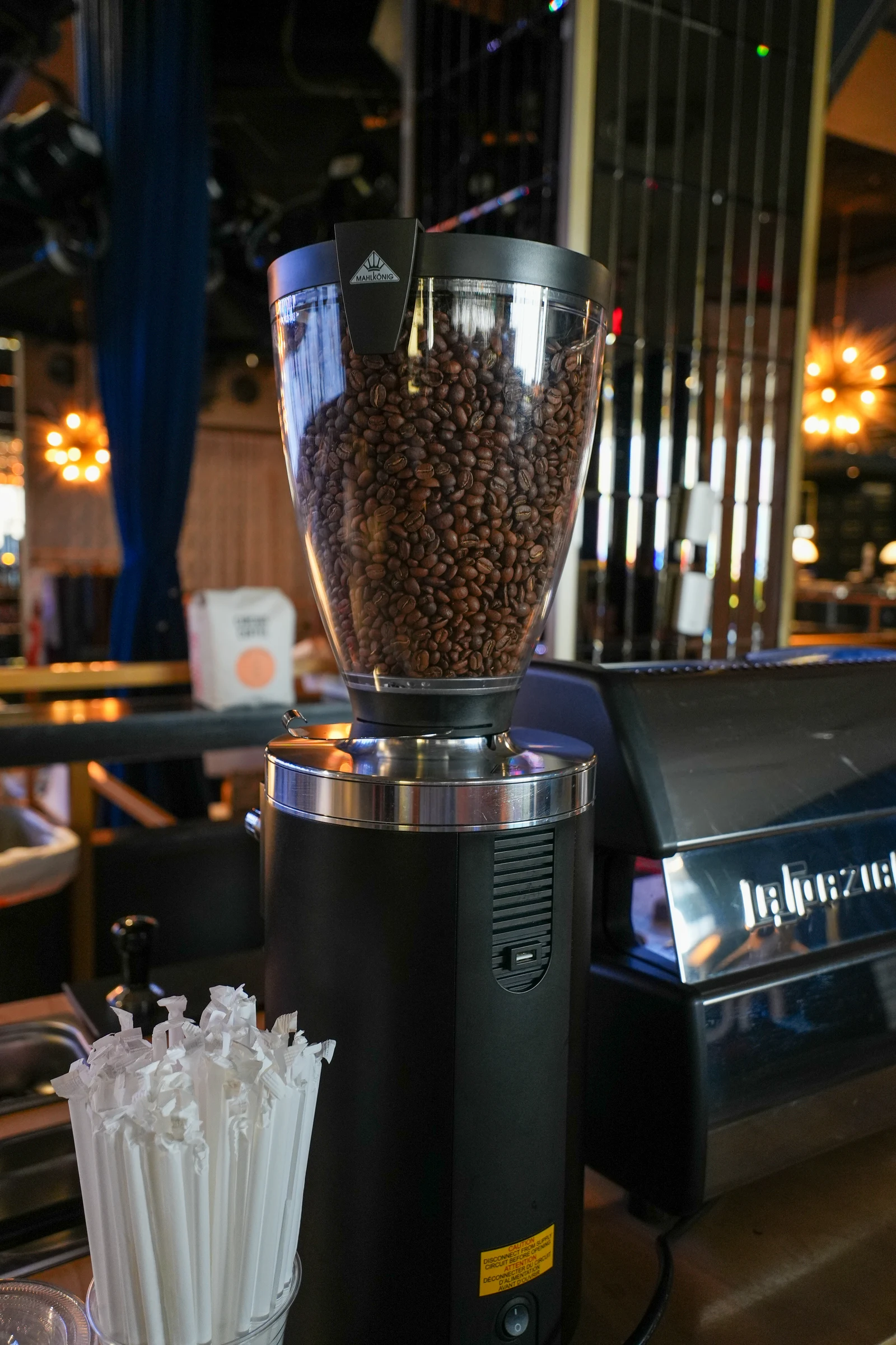 Coffee beans in the Bloom cart’s grinder beside the espresso machine