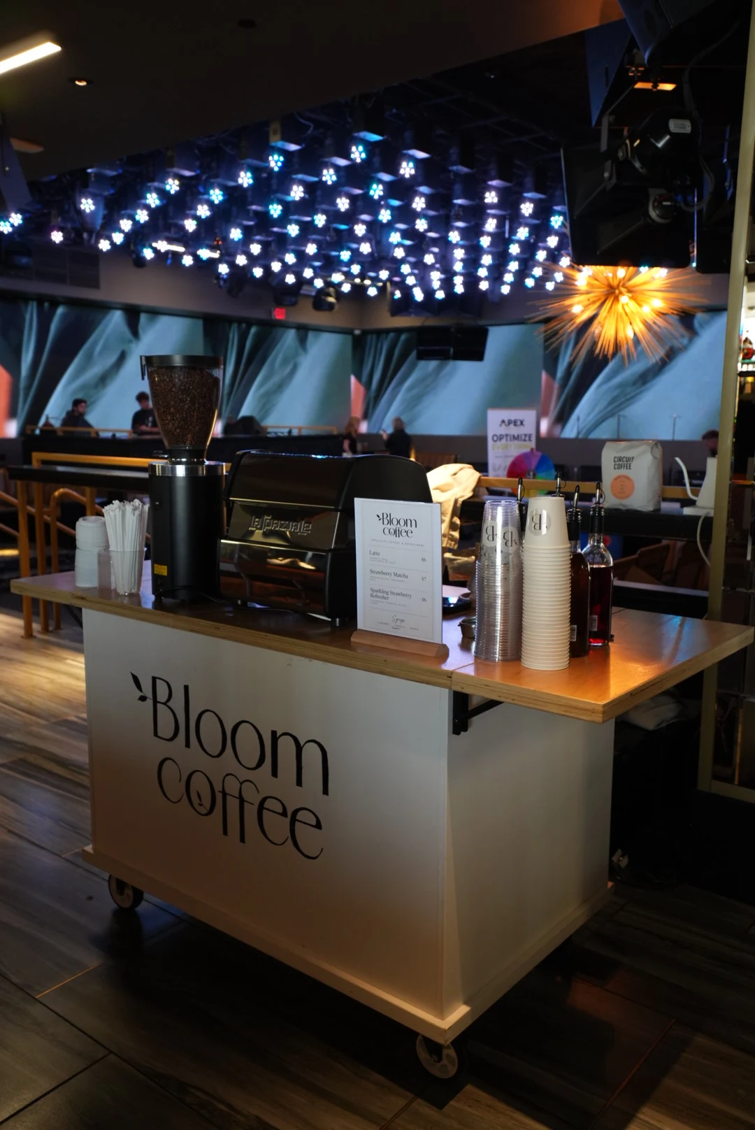 Bloom Coffee cart with its espresso machine and menu at an event