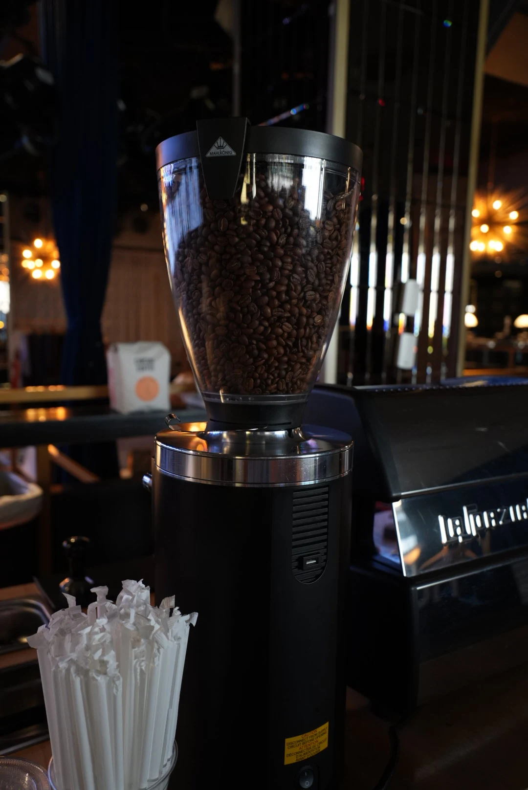 Close-up of the coffee grinder and espresso machine at an evening event